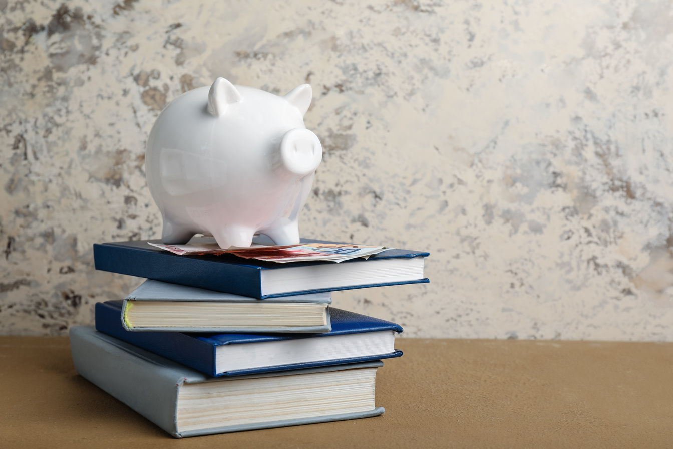 Piggy Bank, Money and Books on Table. Tuition Fees Concept